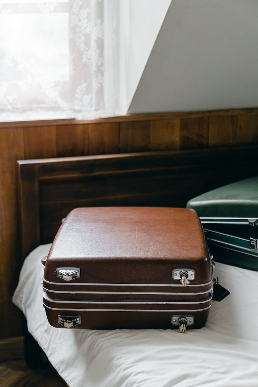 suitcases placed on edge of bed